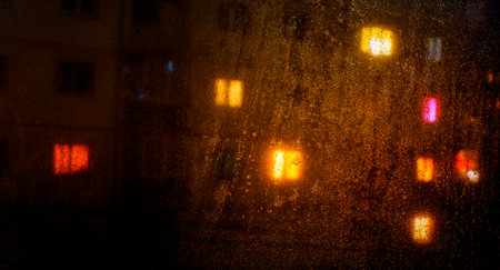 Water drops reflections on the window in nightの写真素材