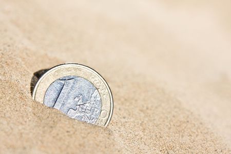 Euro coin in the sandの写真素材
