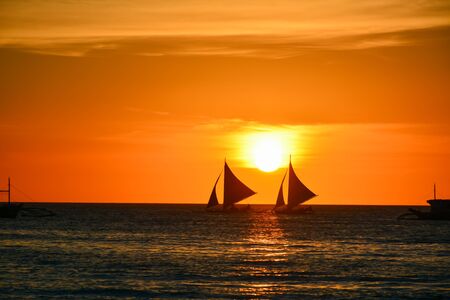Sunset in Boracay, Philippines with a boat in the foreground