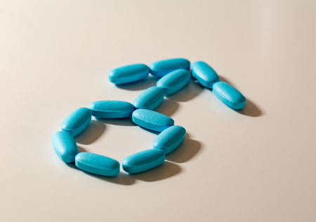 Man symbol formed by blue tablets whose color is reminiscent of a drug against the erection problemsの写真素材