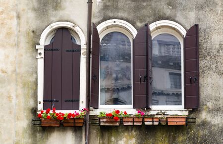 Building facade in Venice with flowersの写真素材