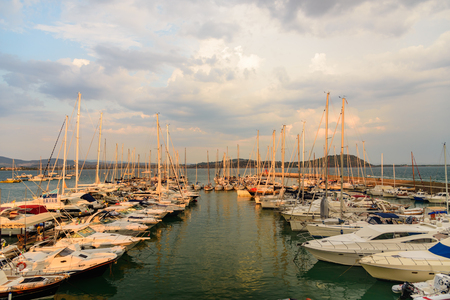 TALAMONE, ITALY - SEPTEMBER 10, 2016 - The small port of the town of Talamone at sunset with moored boats.のeditorial素材