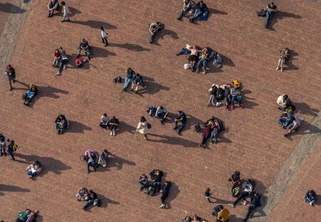 SIENA, ITALY, MARCH 19, 2017 - Tourists and locals relax, lying down in Piazza del Campo, the main and famous square of Siena.のeditorial素材