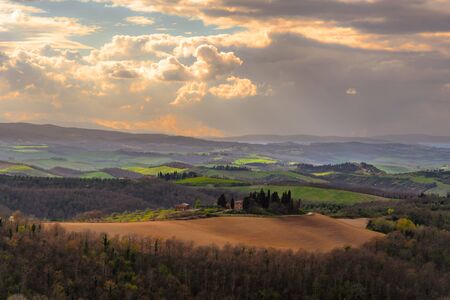 SIENA, ITALY - MARCH 26, 2017 - View of the countryside near Siena, Italy with a house surronded by cypress trees.のeditorial素材