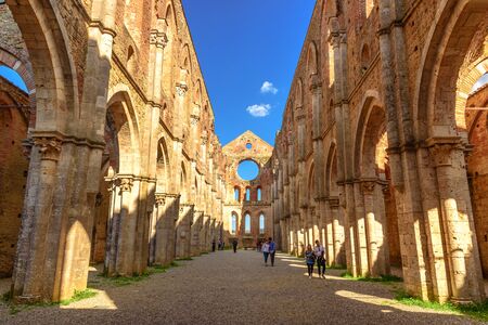 SIENA, ITALY - APRIL 9, 2017 - Some tourists admire the Abbey of San Galgano in Chiusdino walking down the center aisle.のeditorial素材