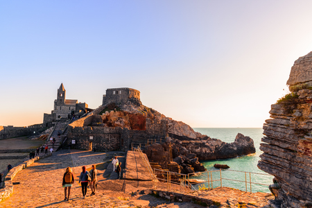 PORTO VENERE, ITALY - APRIL 30, 2017 - A scenic view of the cathedral of Porto Venere at sunset with people walk and admire the view.のeditorial素材