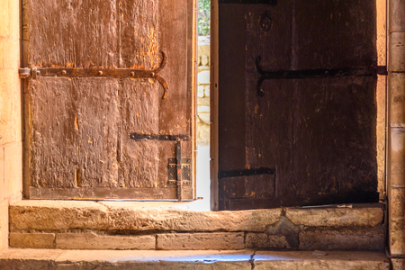 An old semi-open wooden doorの写真素材