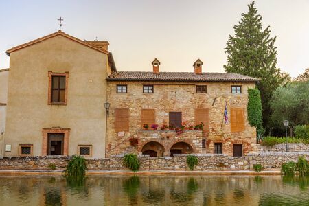 BAGNO VIGNONI, ITALY - JULY 23, 2017 - View of the church and the medieval thermal baths in Bagno Vignoni a small village in Val'd'Orcia.のeditorial素材