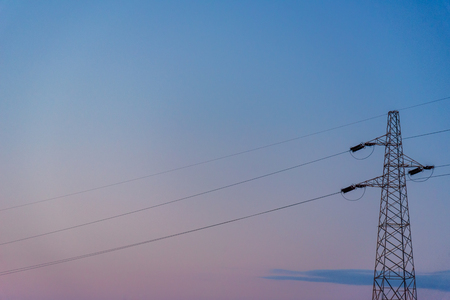 Silhouette of a powerline at sunset.の写真素材