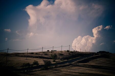 Country road and light poles. Retro photo.の写真素材