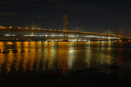 Night view of the Forth Rail Bridge in Edinburgh. The bridge that connects the scottish towns of North and South Queens ferryの写真素材