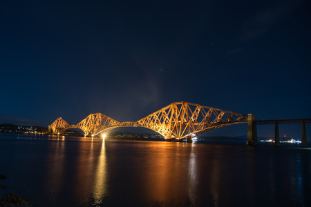 Night view of the Forth Rail Bridge in Edinburgh. The bridge that connects the scottish towns of North and South Queens ferryの写真素材