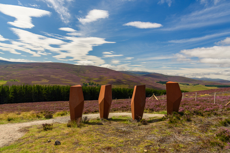 INVERNESS, SCOTLAND - AUGUST 10, 2017 - Chair-shaped sculptures overlooking a magnificent view of Cairngorms National Park in Scotlandのeditorial素材