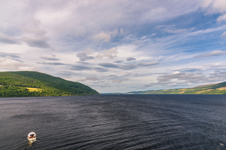 View of Loch Ness from the top of Urquhart Castle in Scotland with a boat.の写真素材
