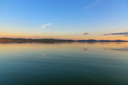 Scenic view of the Lake Trasimeno, Umbria, Italy at sunsetの写真素材