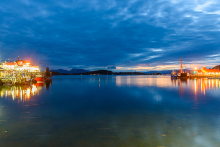 OBAN, SCOTLAND - AUGUST 14, 2017 - Night view of the bay of the beautiful town of Oban with lights reflection.のeditorial素材