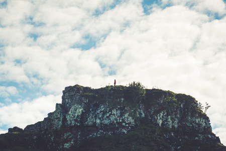 Tourist hiking the Mystic Fairy Glen, a romantic green valley in the Isle of Skye. Retro photo.の写真素材