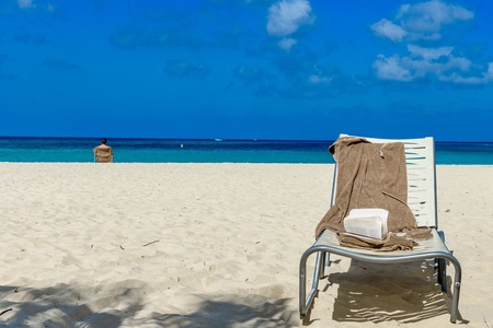 Sunbeds with a book in a caribbean landscape in Aruba.の写真素材