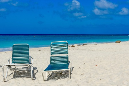 Sunbeds on the dreamy Eagle Beach in Aruba. Caribbean landscape.の写真素材