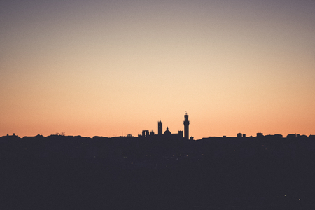 Silhouette of the medieval city of Siena, Tuscany, Italy at sunset.の写真素材