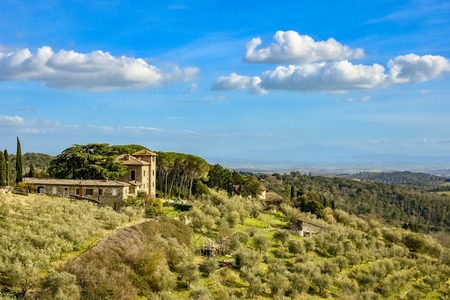 Vagliagli, Italy - April 2, 2018: View of a villa in Chianti area in Tuscany above a valley of olive trees.のeditorial素材