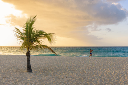 Oranjestad, Aruba - January 9, 2018: A gay couple stroll romantically on the idyllic Eagle Beach in Aruba.のeditorial素材
