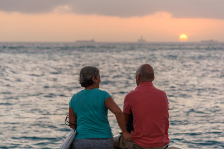 Oranjestad, Aruba - January 8, 2018: A couple admire a romantic sunset in Oranjestad.のeditorial素材