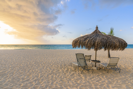 Sun beds and umbrella on a caribbean beach. Tropical landscape.の写真素材