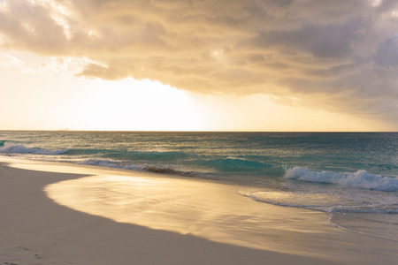 View of a tropical caribbean beach at sunset.