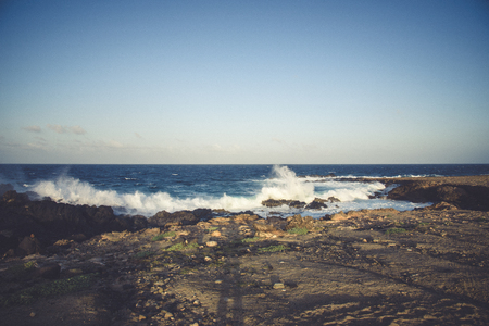 The force of the sea in Aruba with waves break on the rocks, near the Natural Bridge.の写真素材
