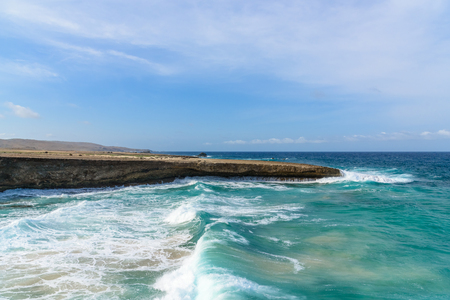 The violent waves of the ocean crashing on the rocksの写真素材