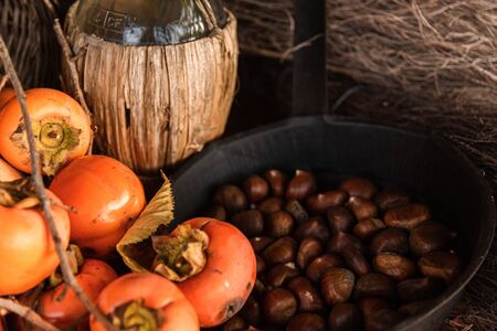 Flat lay composition with chestnust, pomegranate and pumpkins on a wooden tableの写真素材
