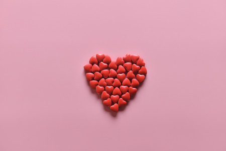 A heart shape of medicine pills on pink background. Concept of Valentine's Day or pharmacy, Medical.の写真素材