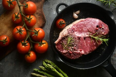 raw marinated meat in iron pan, with ingredients surrounding. top view,flat lay, horizontal image.の写真素材