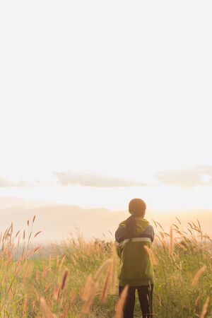 standing on a mountain, enjoying the sunset