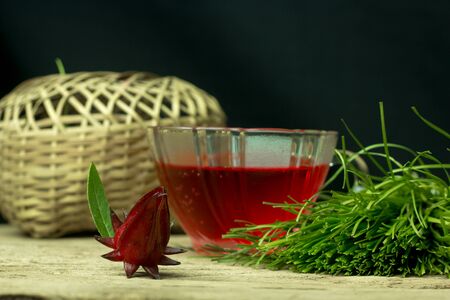Glass of cold roselle juice - healthy food against woodの写真素材