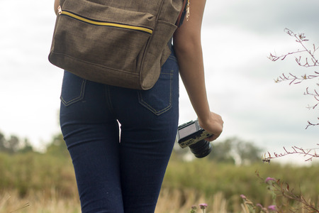 travel, hiking, backpacking, tourism and people concept - happy with backpacks walking along farm.の写真素材