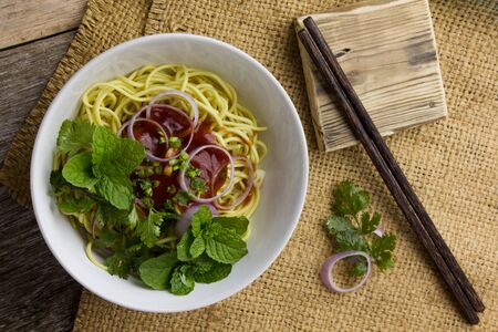 The spaghetti in a white plate on the table.Rustic plate of tasty spaghetti Bolognaise topped with...