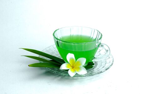 Glass of cold Pandan juice - healthy food against wood,With pandan greenon a white backgroundの写真素材