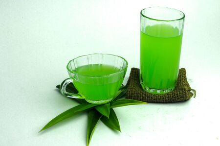 Glass of cold Pandan juice - healthy food against wood,With pandan greenon a white backgroundの写真素材