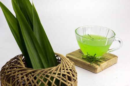 Glass of cold Pandan juice - healthy food against wood,With pandan greenon a white backgroundの写真素材
