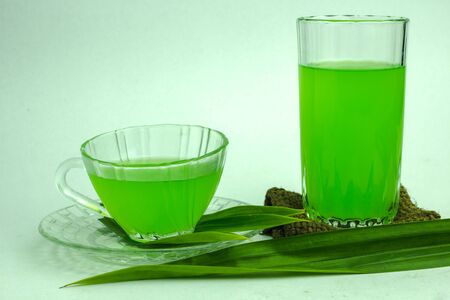 Glass of cold Pandan juice - healthy food against wood,With pandan greenon a white backgroundの写真素材