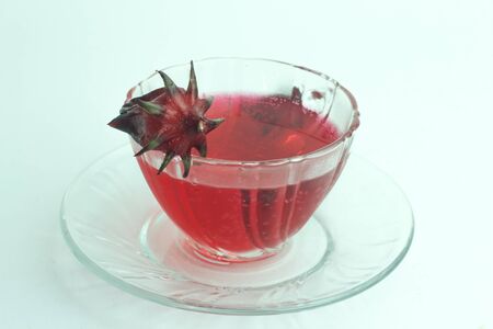 Glass of cold roselle juice - healthy food against woodの写真素材