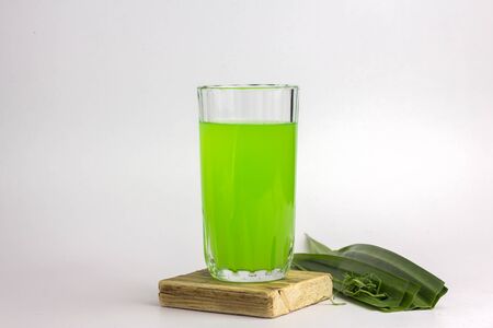 Glass of cold Pandan juice - healthy food against wood,With pandan greenon a white backgroundの写真素材