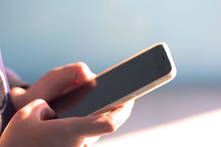 Closeup of female hand using a smart phone. Shallow depth of field,Close up of woman using a smart phone.の写真素材