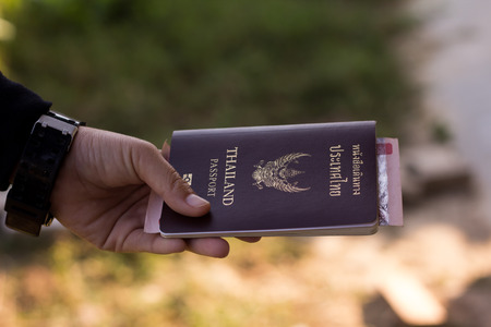 Passport in hand Woman.Passport in hand.の写真素材