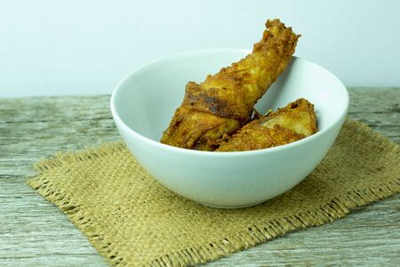 Roasted chicken on black plate at wooden table.の写真素材