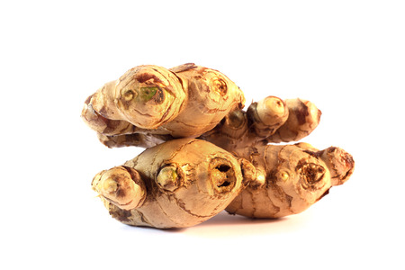 Root ginger isolated on a white studio background.