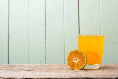juice with slice of orange isolated on woods background.の写真素材