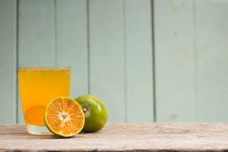 juice with slice of orange isolated on woods background.の写真素材